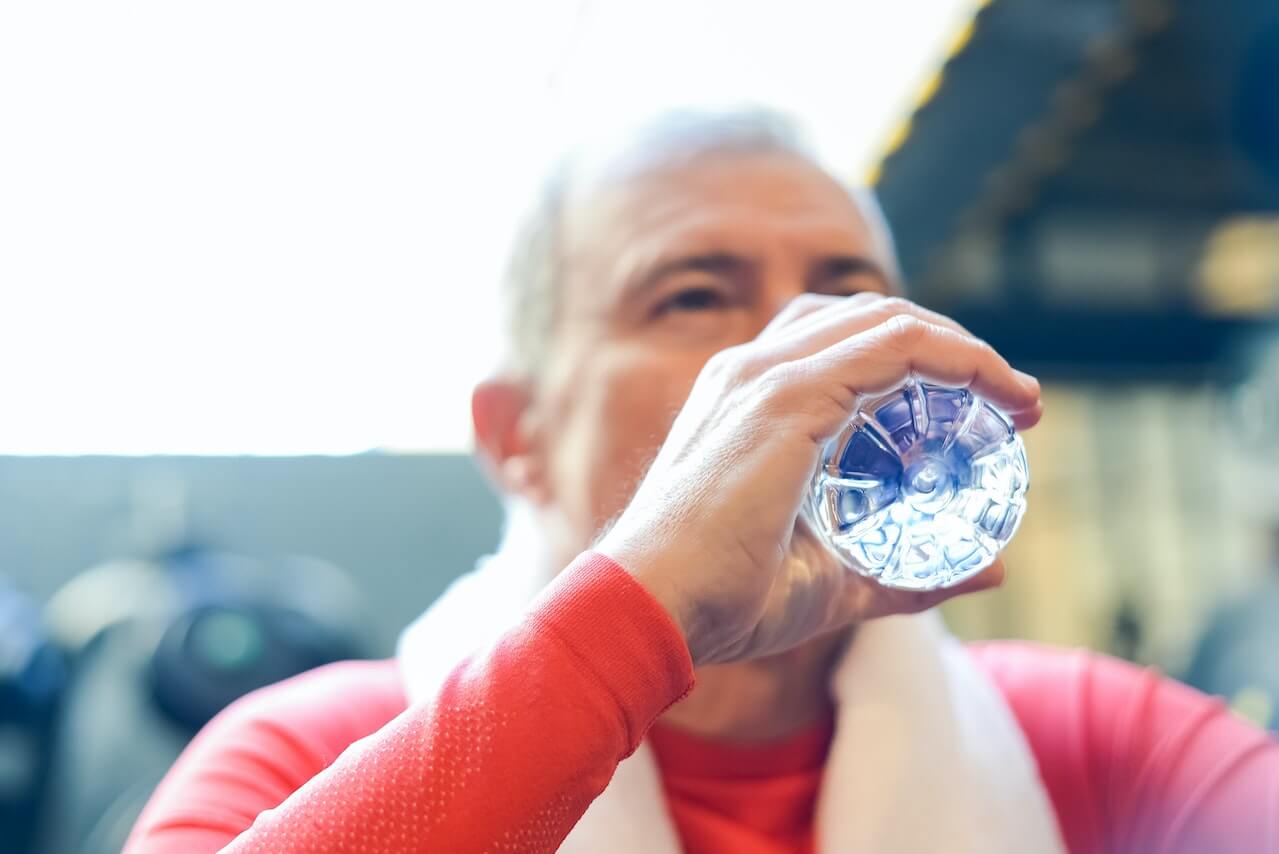 Close-up-of-man-drinking-from-water-bottle