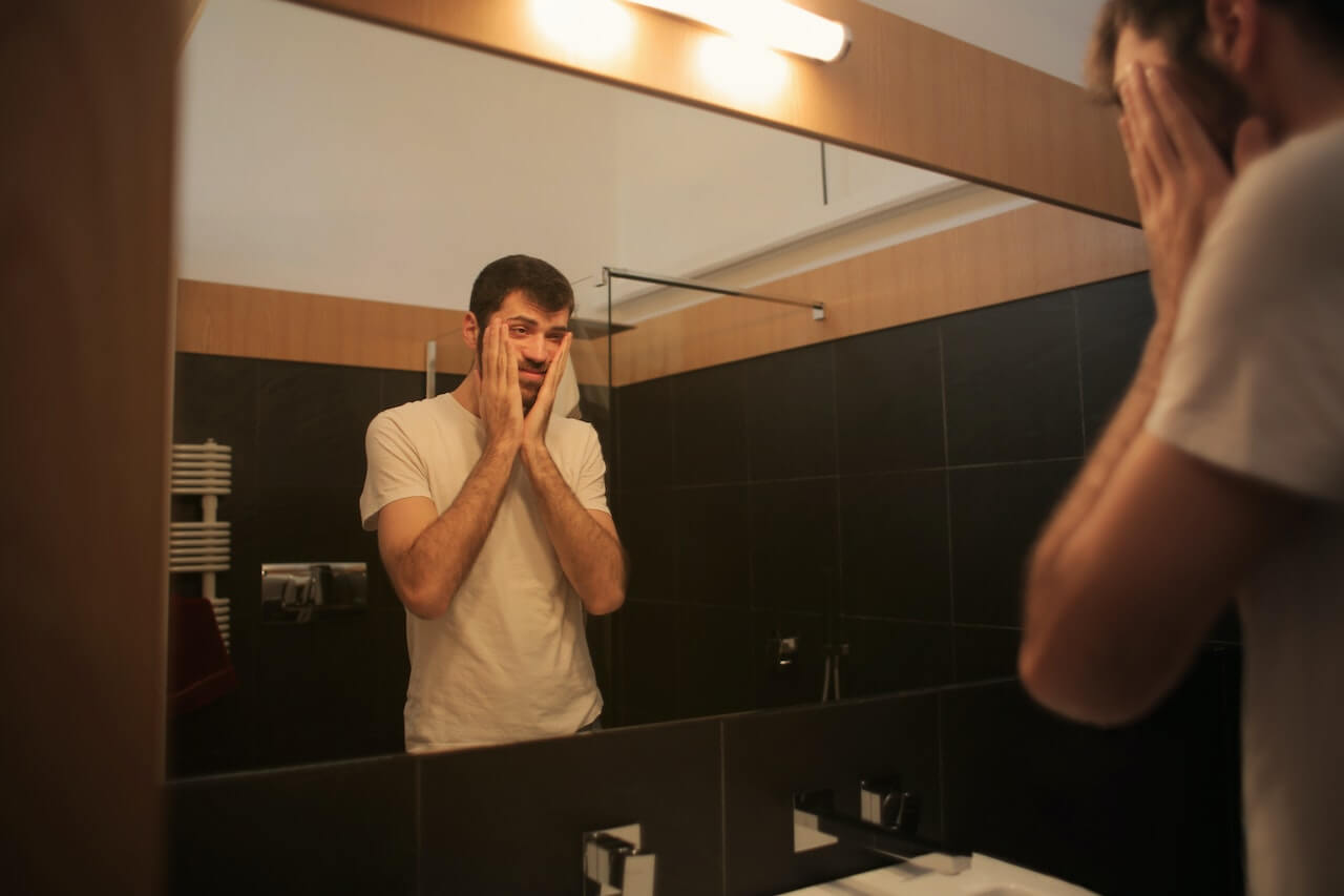 tired-man-looking-in-the-mirror