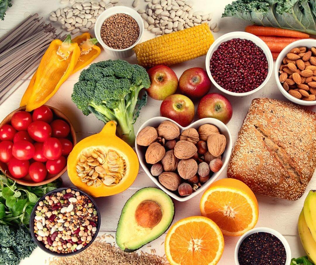 an array of healthy whole foods on a white table