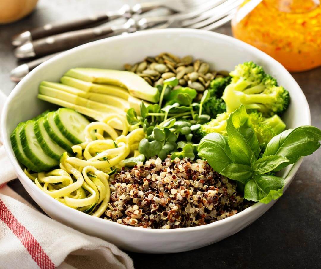 bowl of quinoa, avocado, broccoli, pumpkin seeds and micro greens