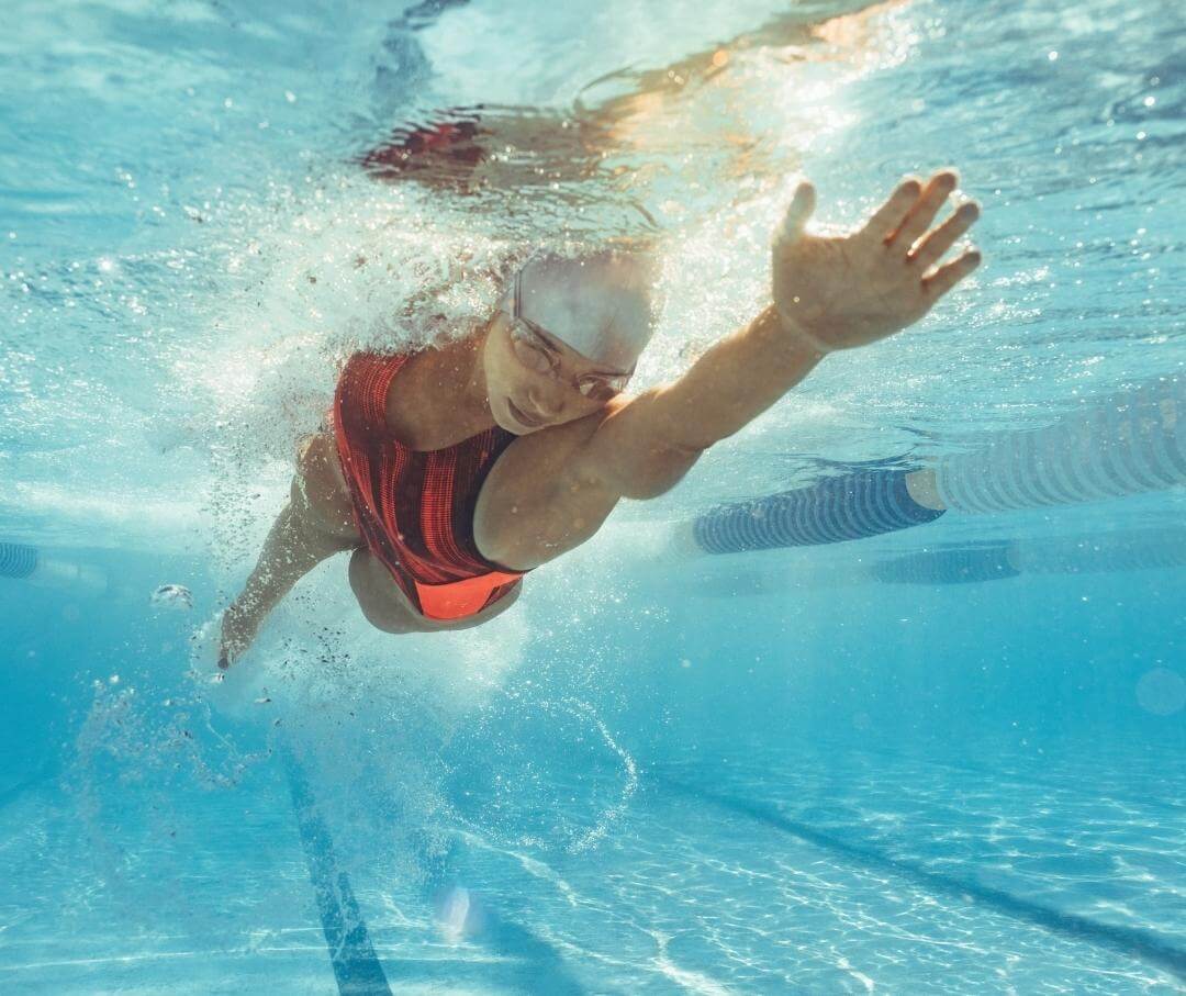 underwater view of woman swimming laps in a pool