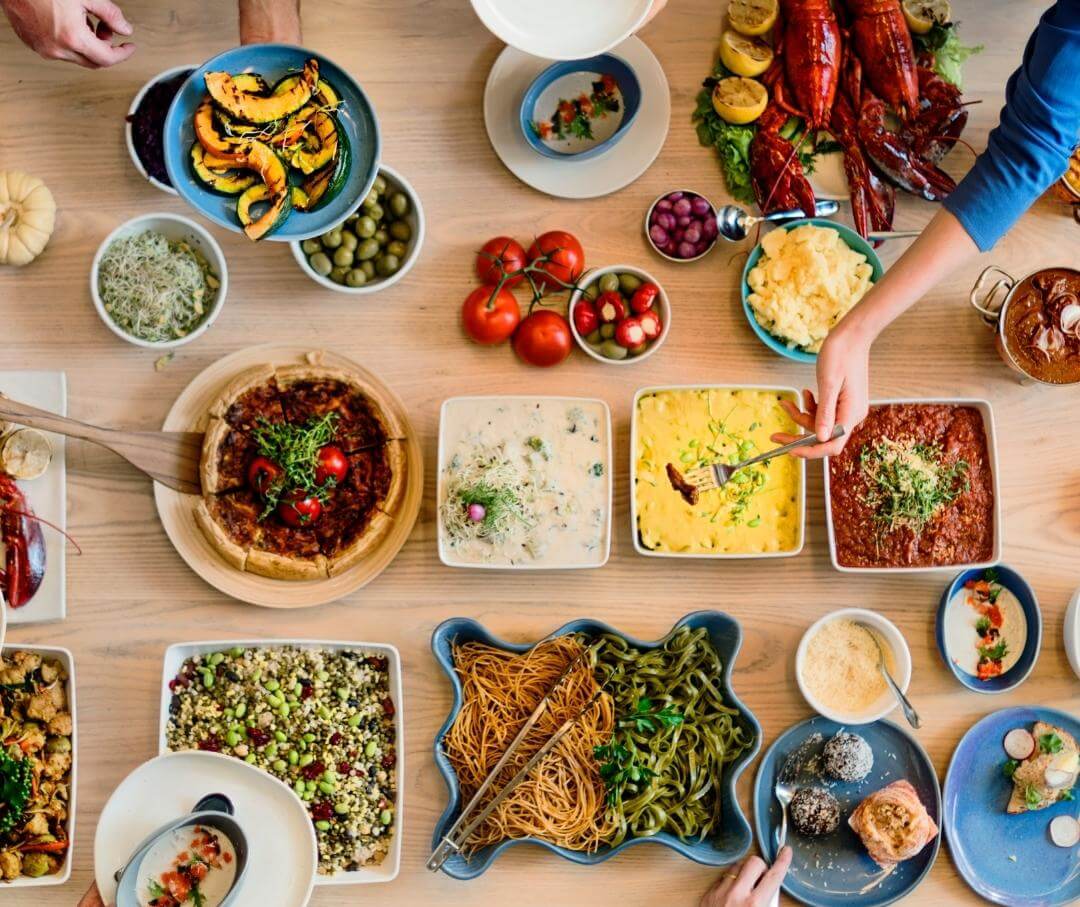 overhead view of wood table with a large variety of food