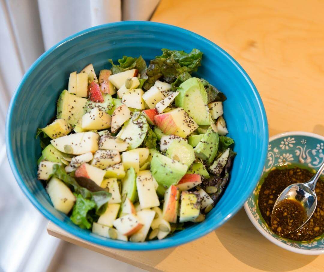 vegetable and fruit salad in a bowl with chia seeds on top