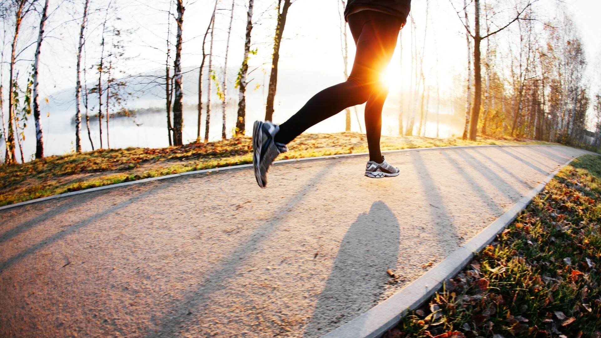 person running on trail at dawn