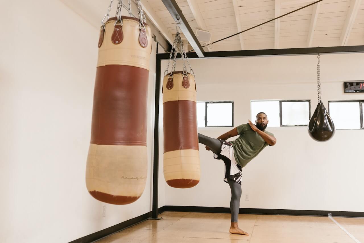 man-kicking-boxing-bag