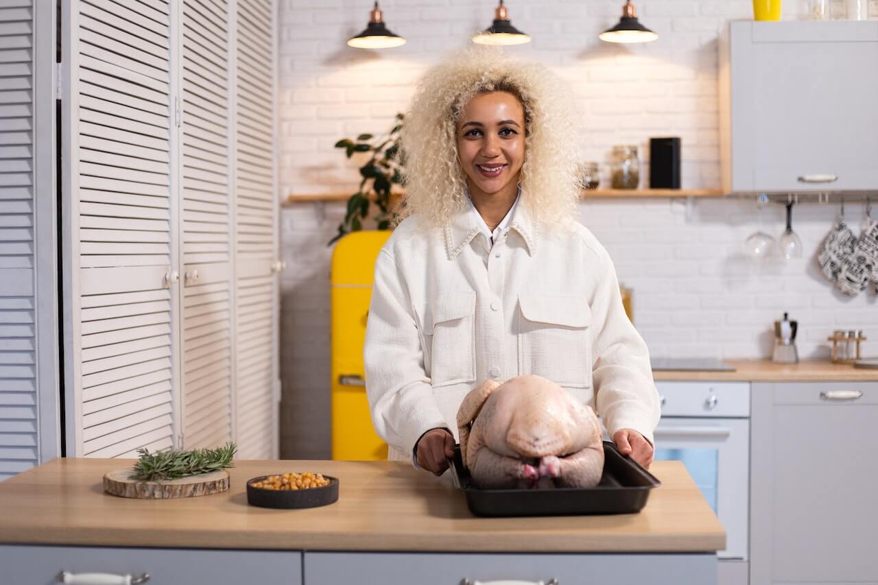 cheerful-woman-with-raw-turkey