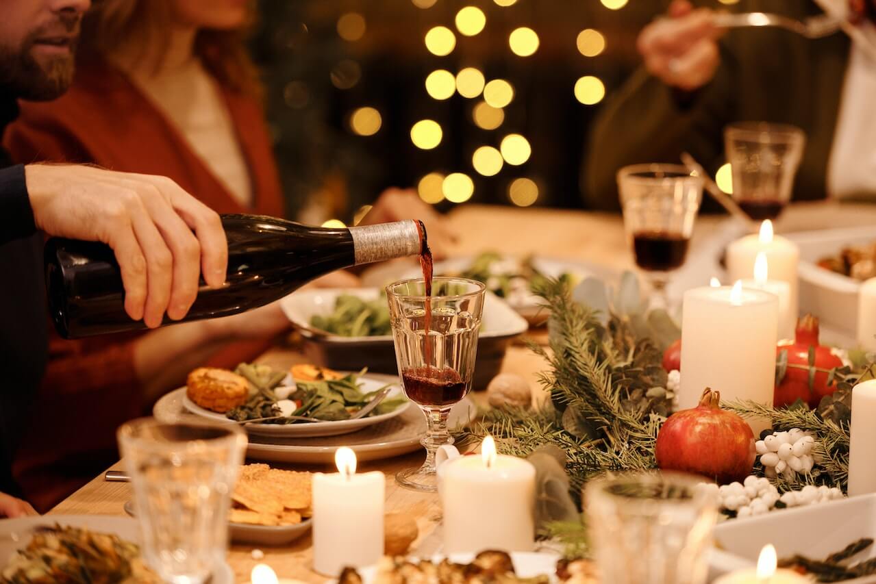 Person-Pouring-Wine-on-Glass-during-dinner