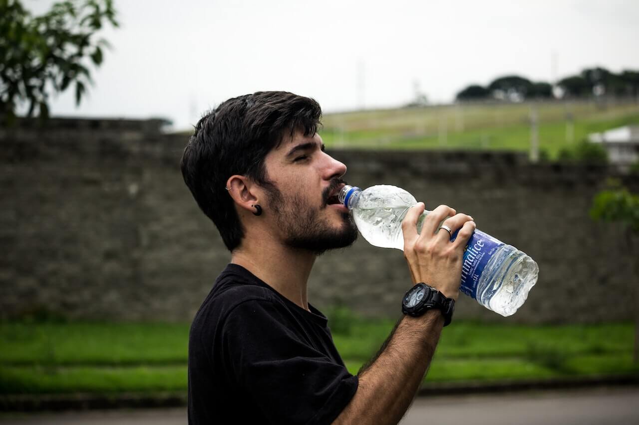 man-drinking-water-after-a-run