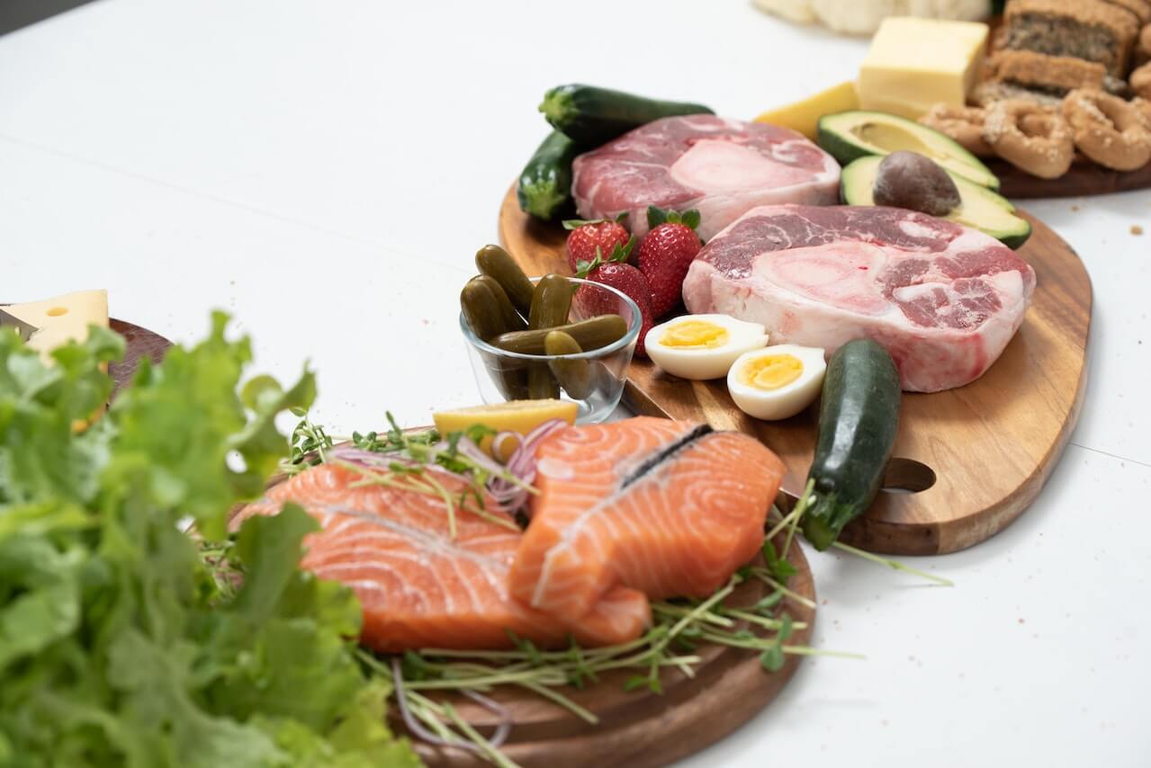 raw-salmon-meat-boiled-eggs-and-vegetables-on-chopping-boards