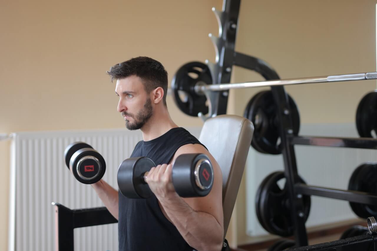 man-working-out-with-dumbbells-at-gym