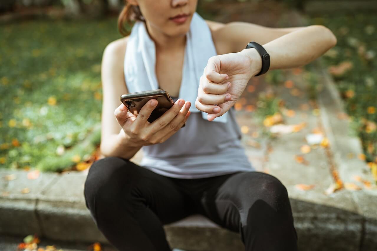 Woman-after-outdoors-run-looking-at-fitness-tracker-watch