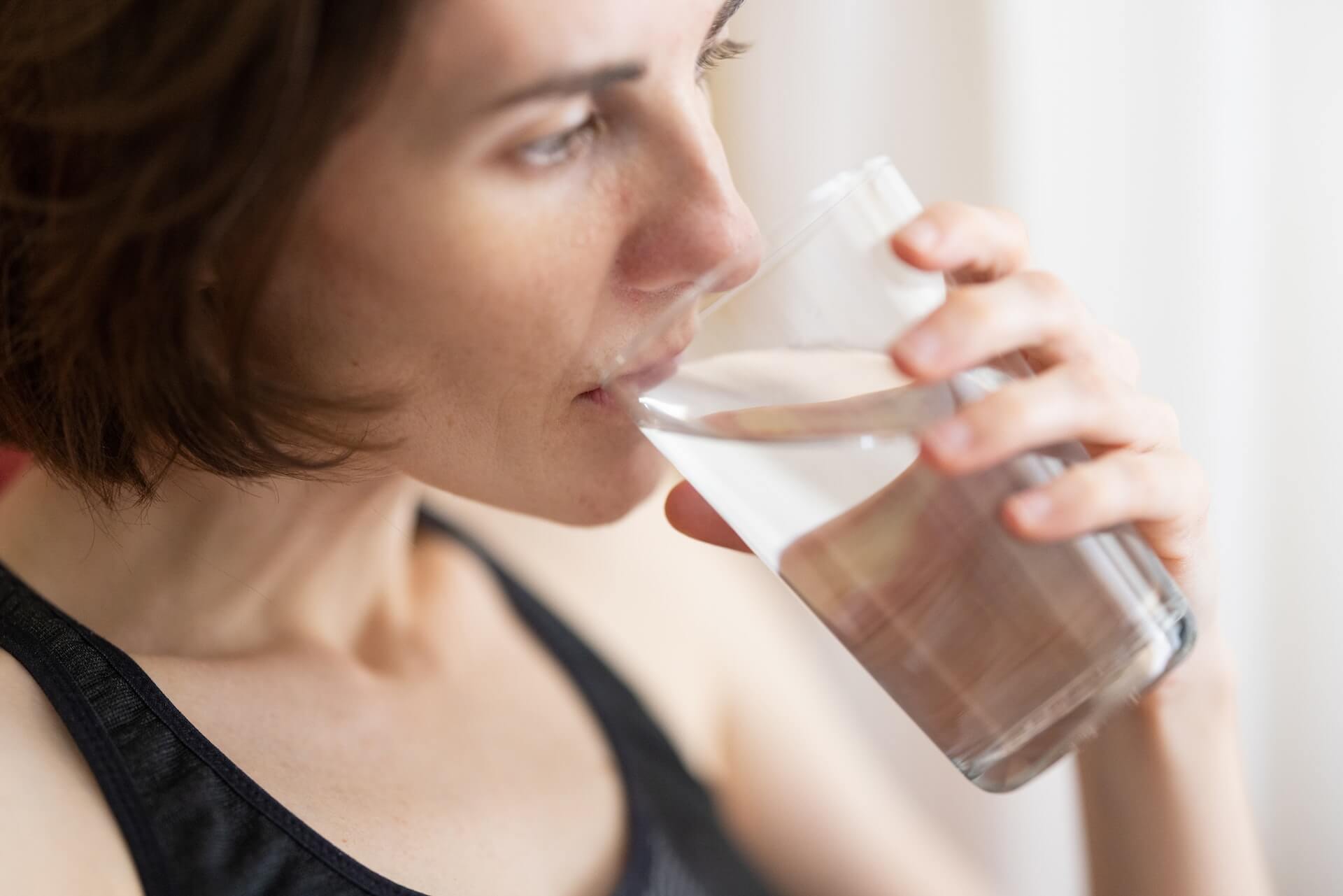 Woman-drinking-water-how-to-lower-estrogen