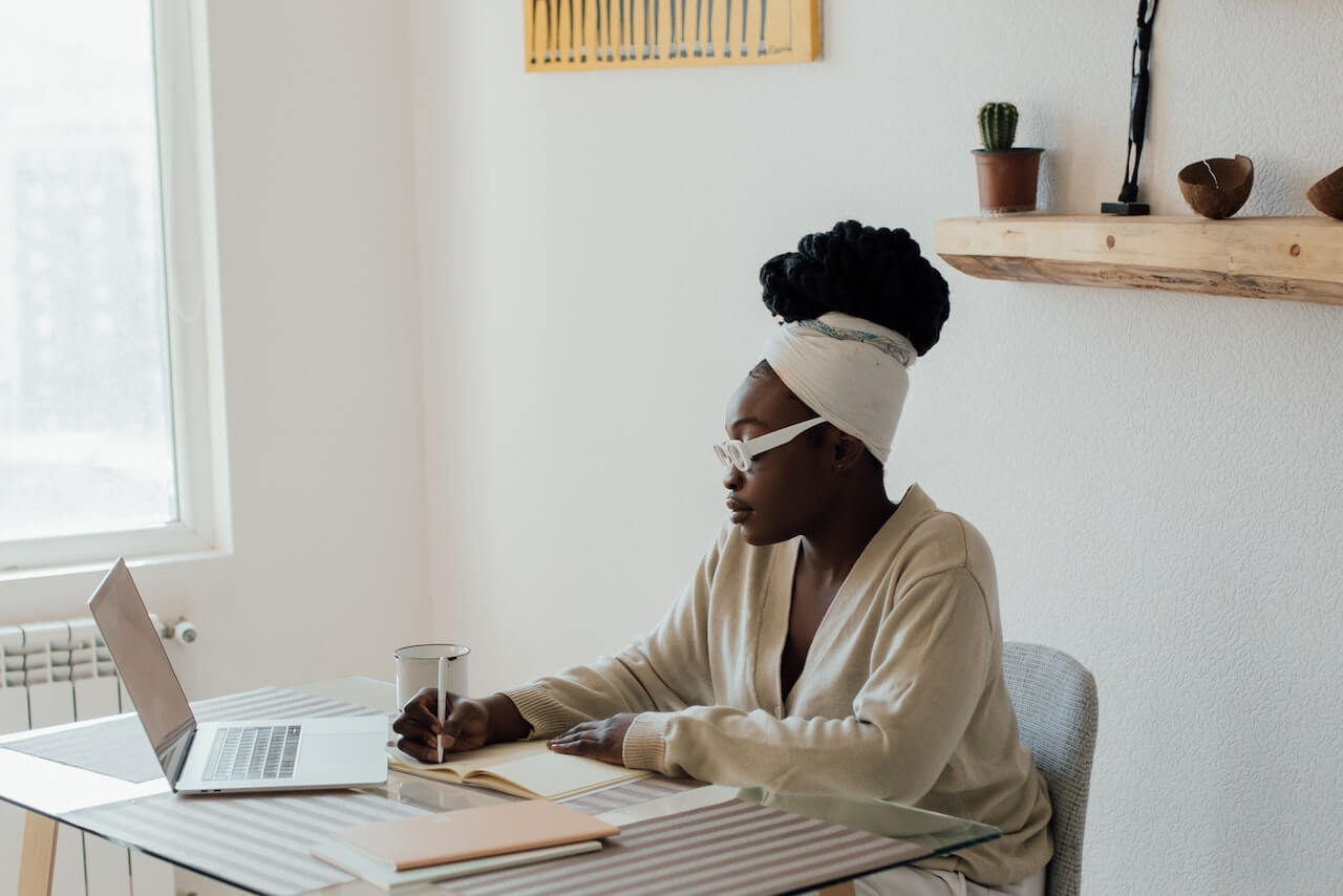 Woman-writing-on-journal-at-home