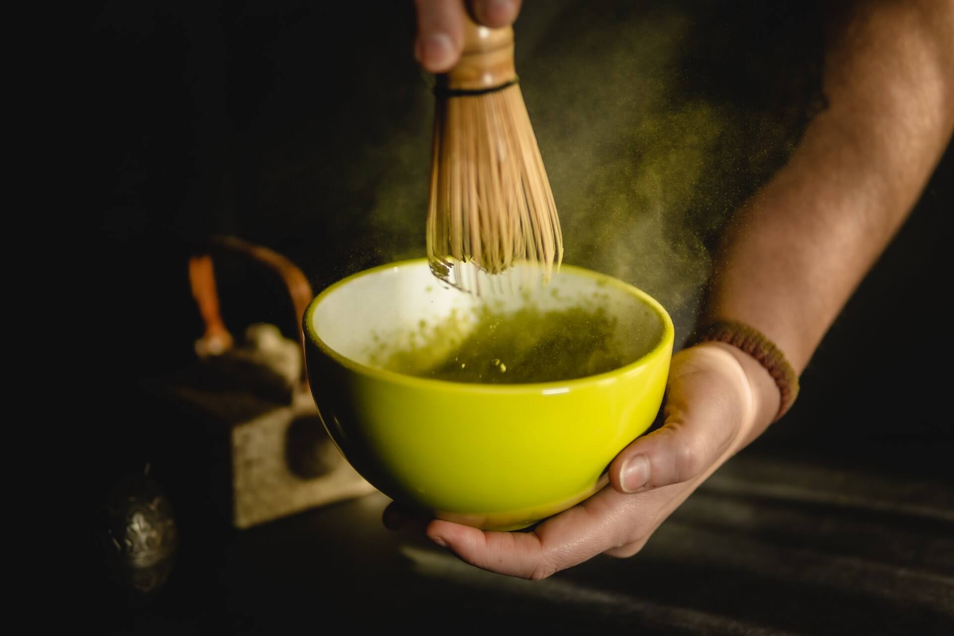 Person-preparing-a-cup-of-matcha-with-the-traditional-tools-is-matcha-good-for-weight-loss