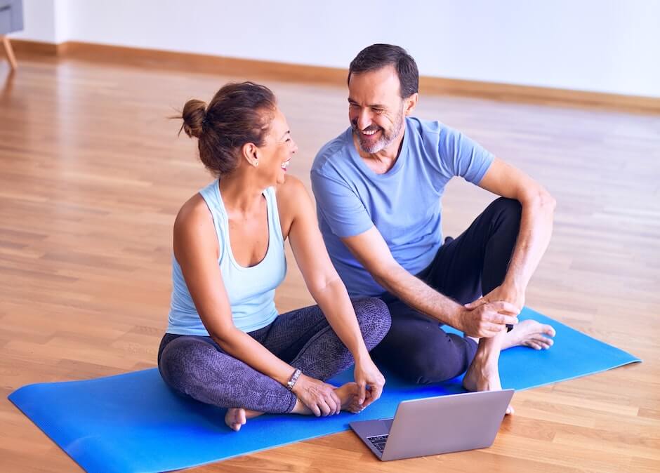 Happy couple laughing in yoga studio