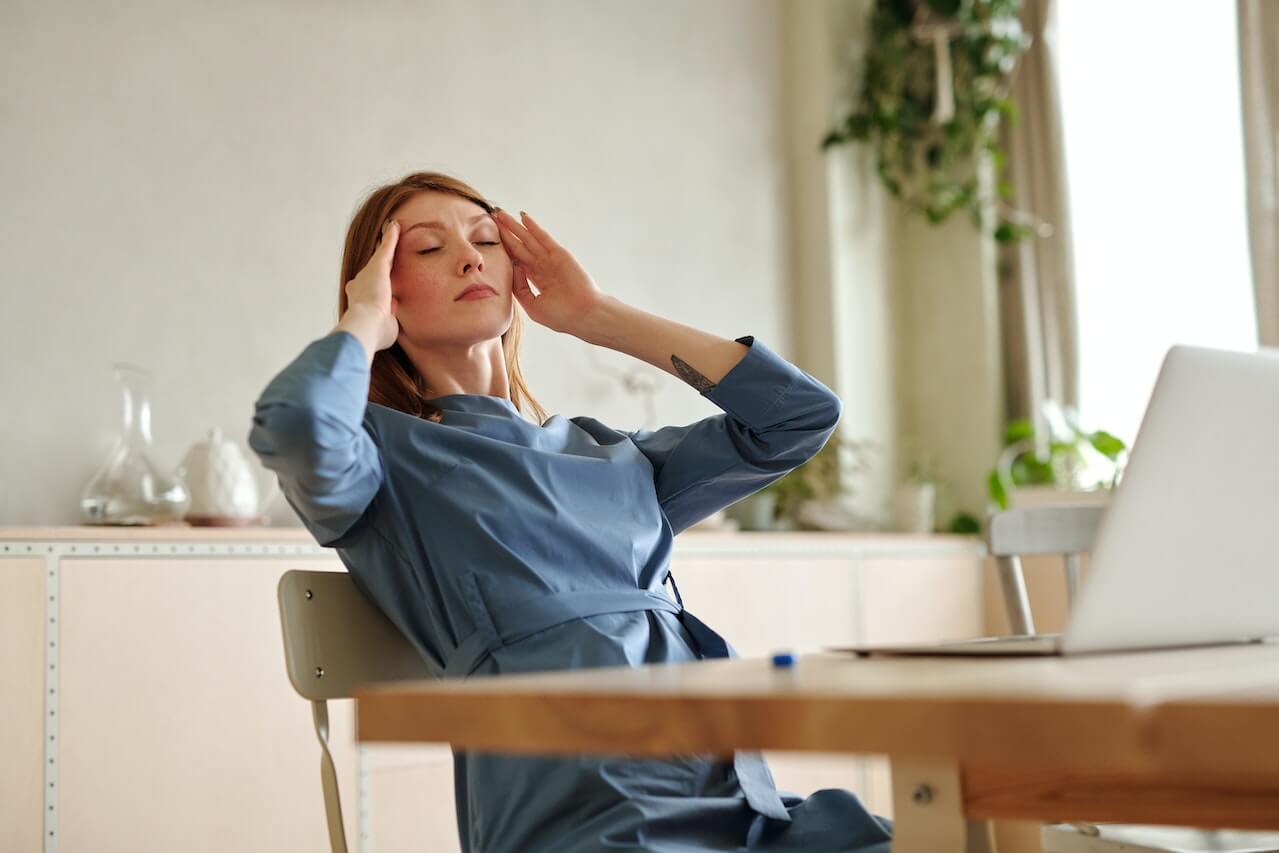 woman-feeling-dizzy-and-with-headache-touching-forehead