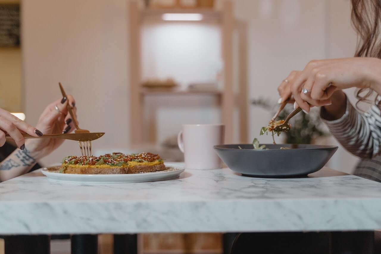 Close-up-of-hands-eating-carb-loaded-meals