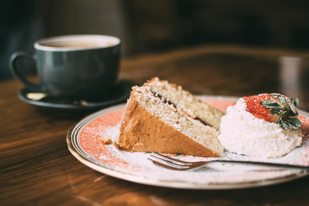 Coffee cake next to a cup of tea