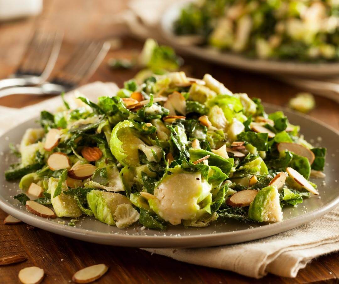 a dish of shaved Brussels sprouts with slivered almonds