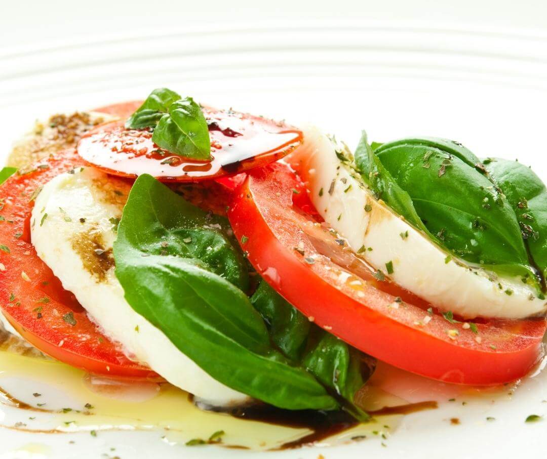 Caprese salad with tomato, mozzarella, basil and olive oil