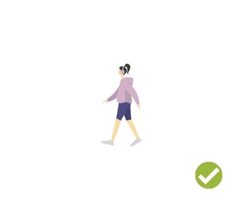 Person walking with headphones over ears