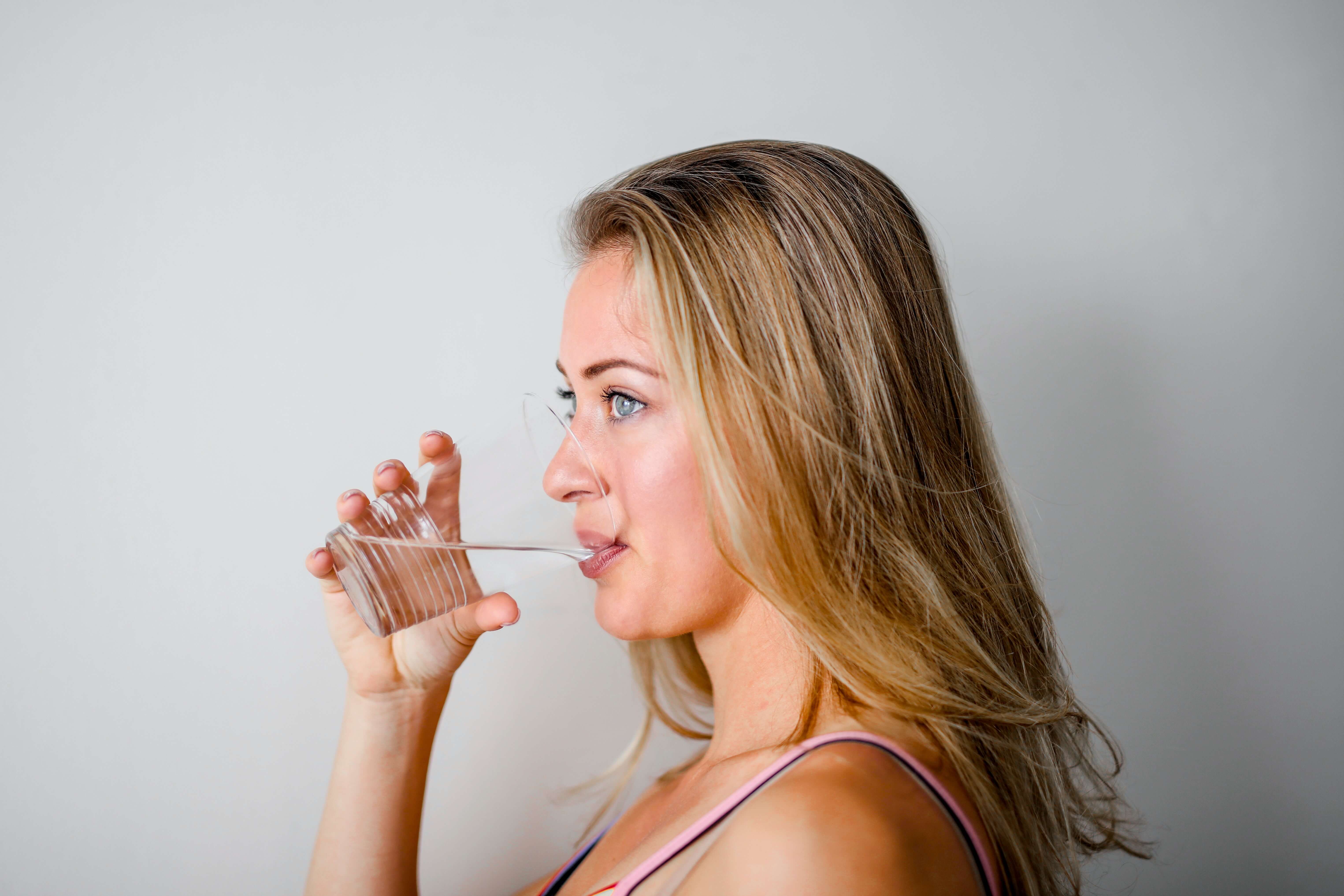 Woman drinking water while fasting