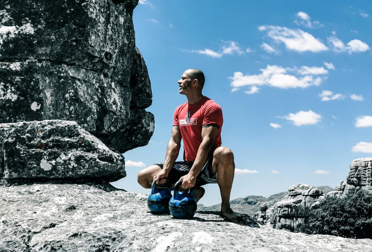 man-holding-kettlebells