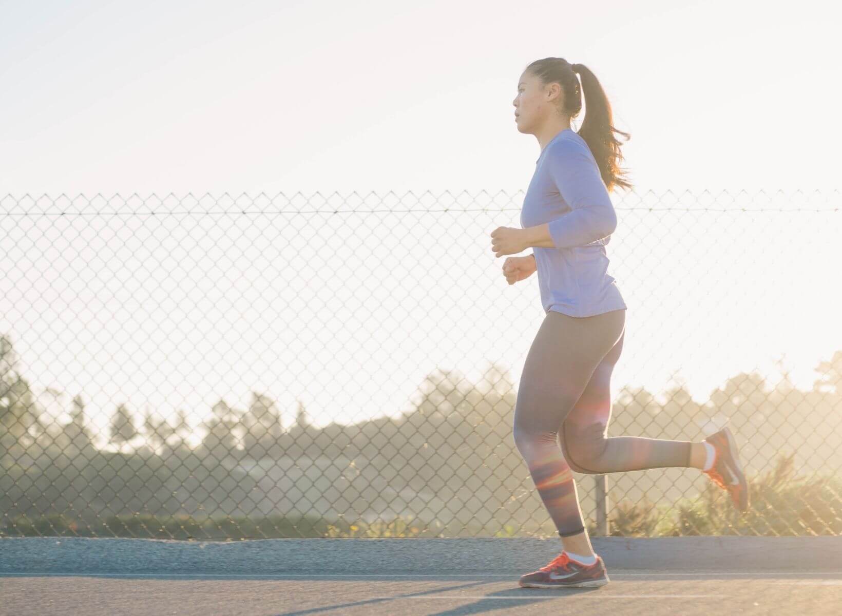 Asian woman running on a track in the early morning