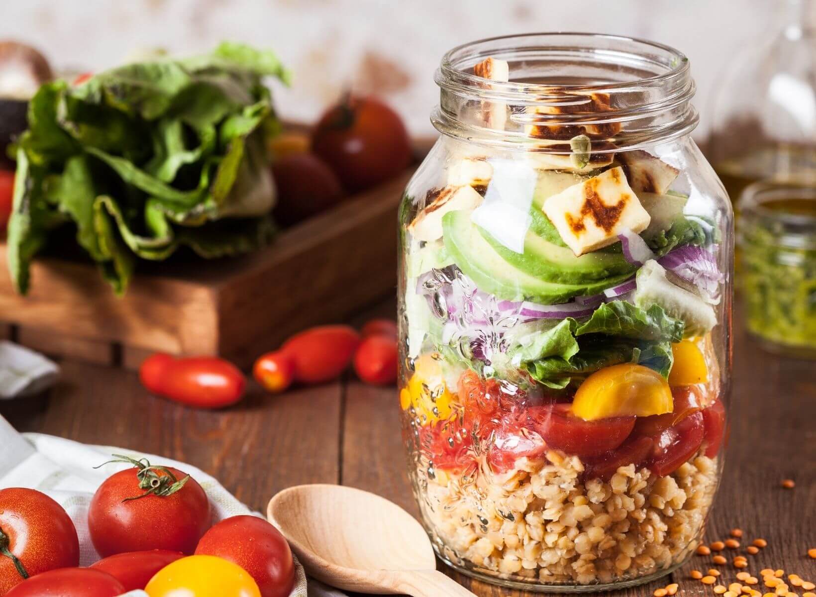 A mason jar salad with barley, vegetables, and tofu