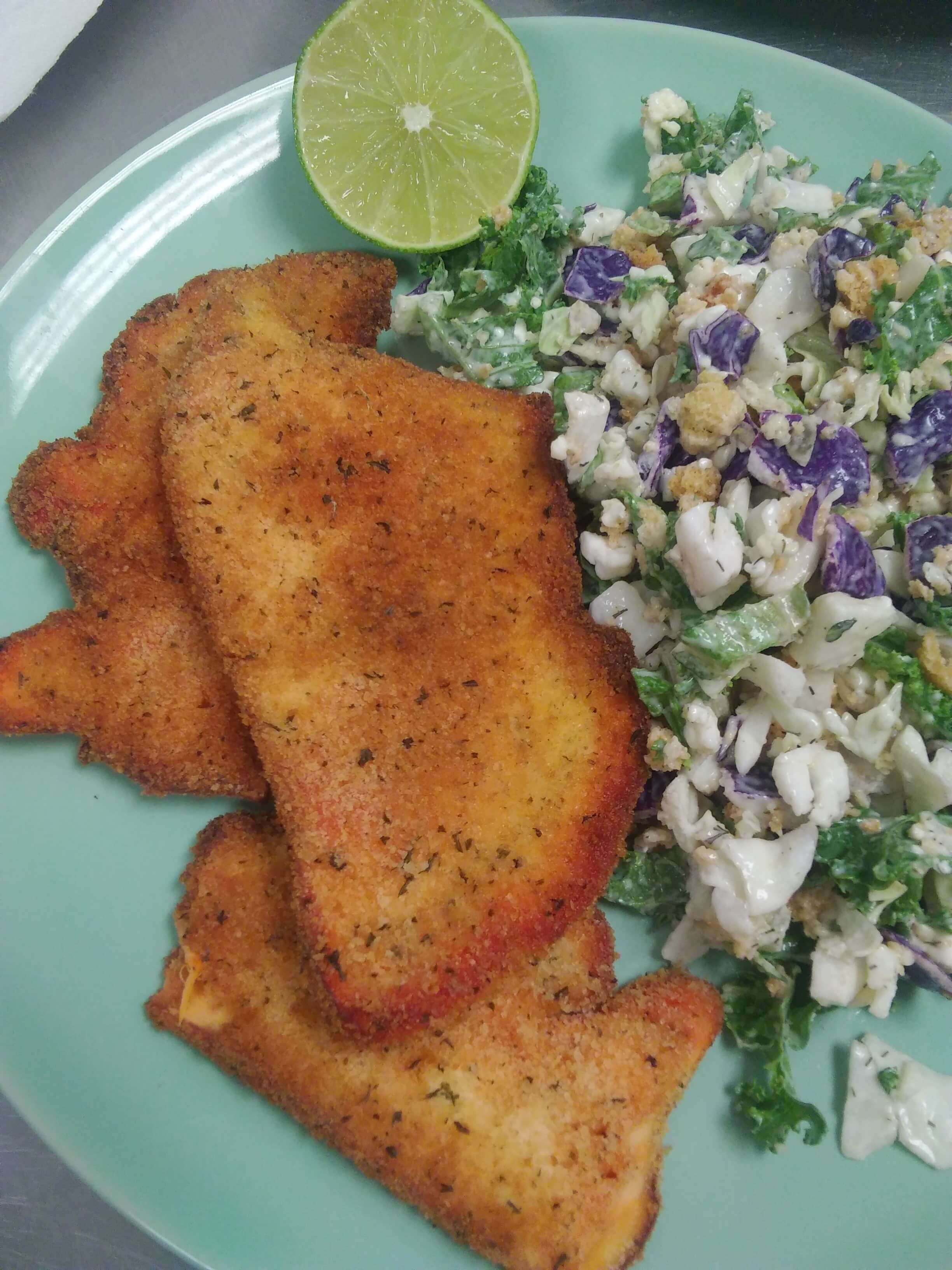 Breaded & prepared 'Chicken of the Woods' mushrooms alongside cabbage slaw.