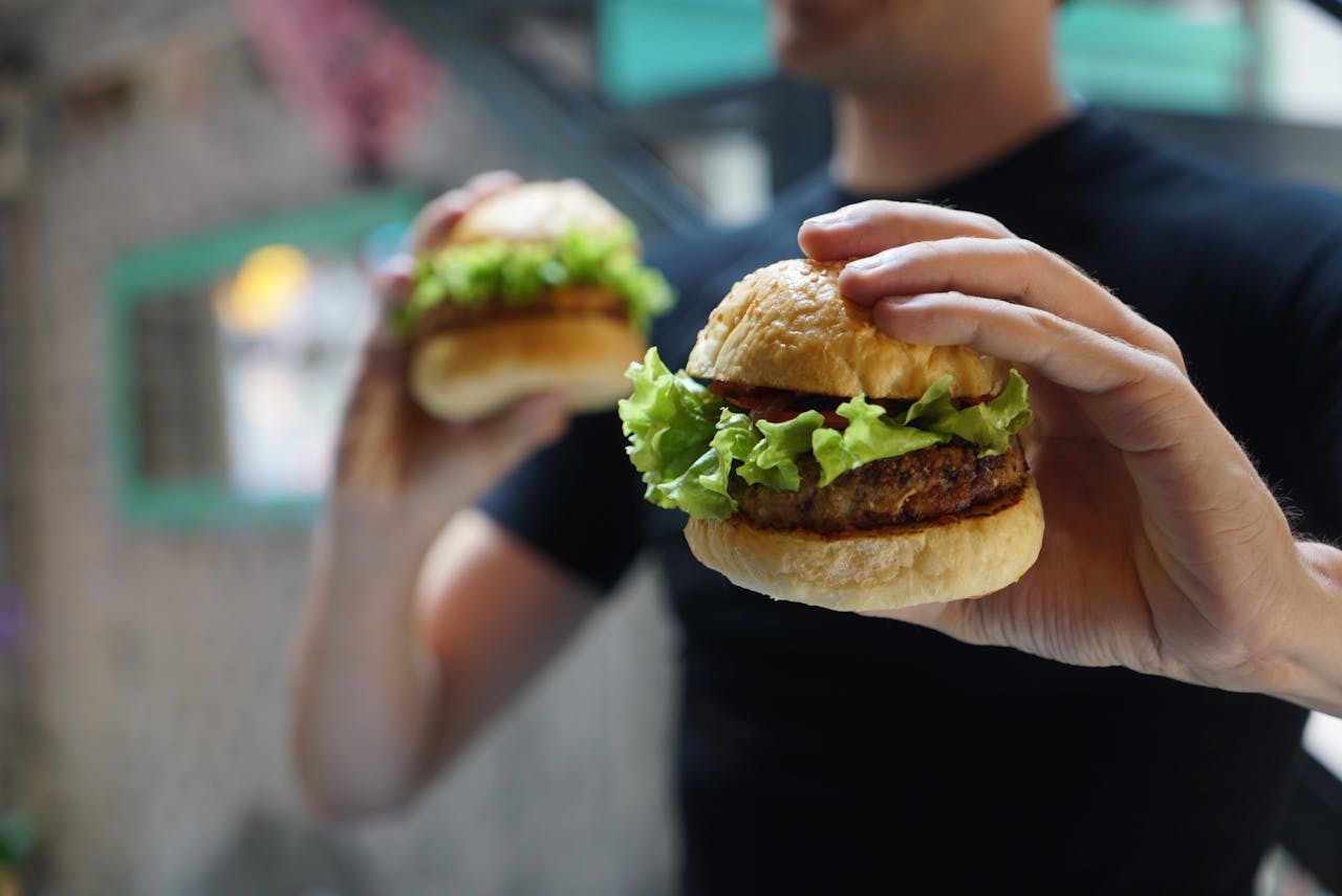 man-holding-two-burguers