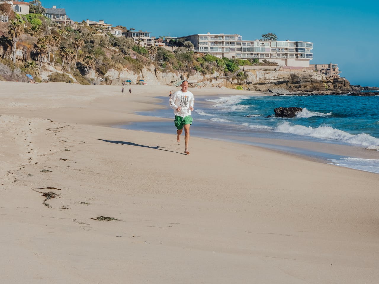 Elderly man running by the coast