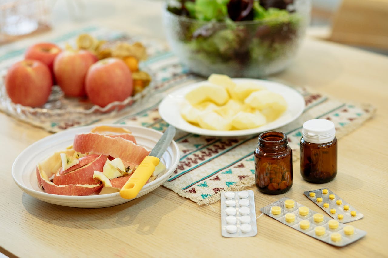 Fruits, vegetables, and supplements on a kitchen table 