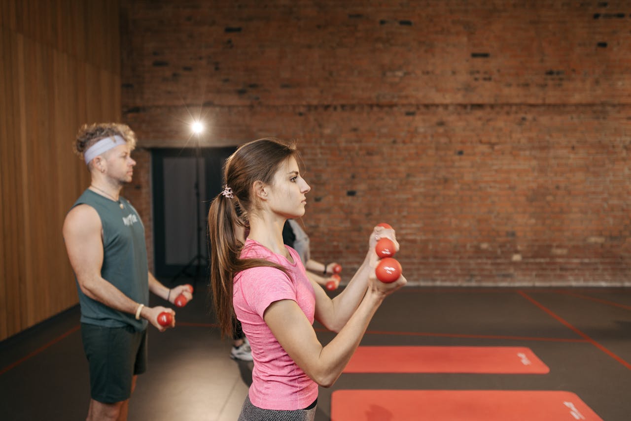 Man and woman doing the callahan press at gym